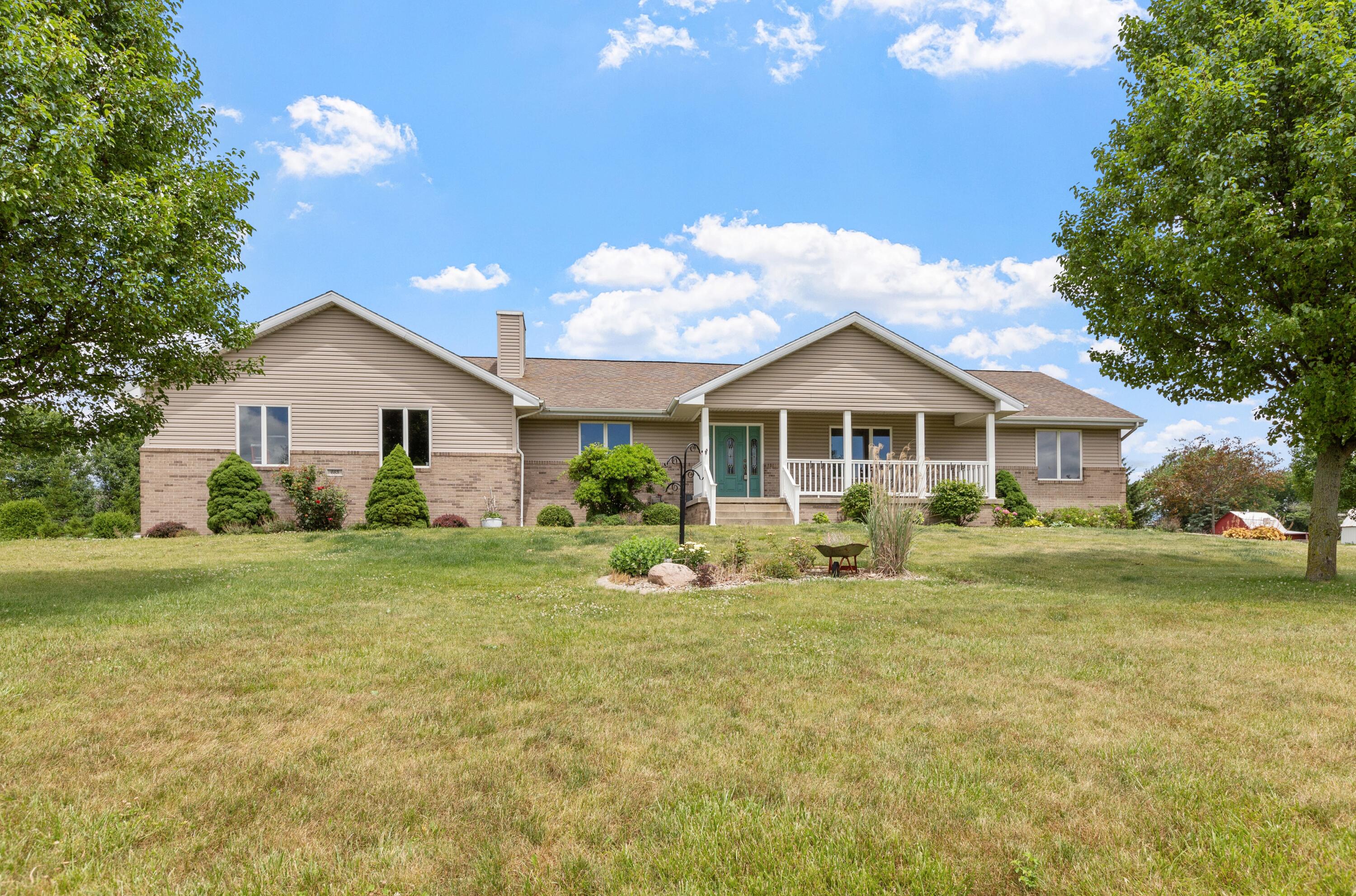 a front view of house with yard and green space