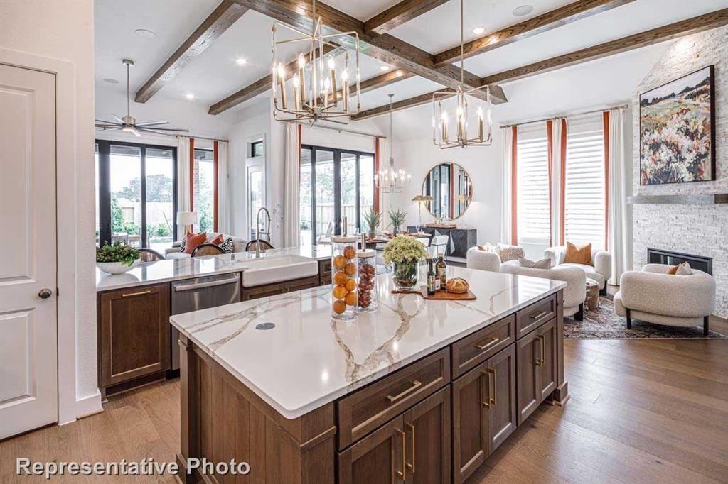 a kitchen with granite countertop a sink a counter top space and living room view