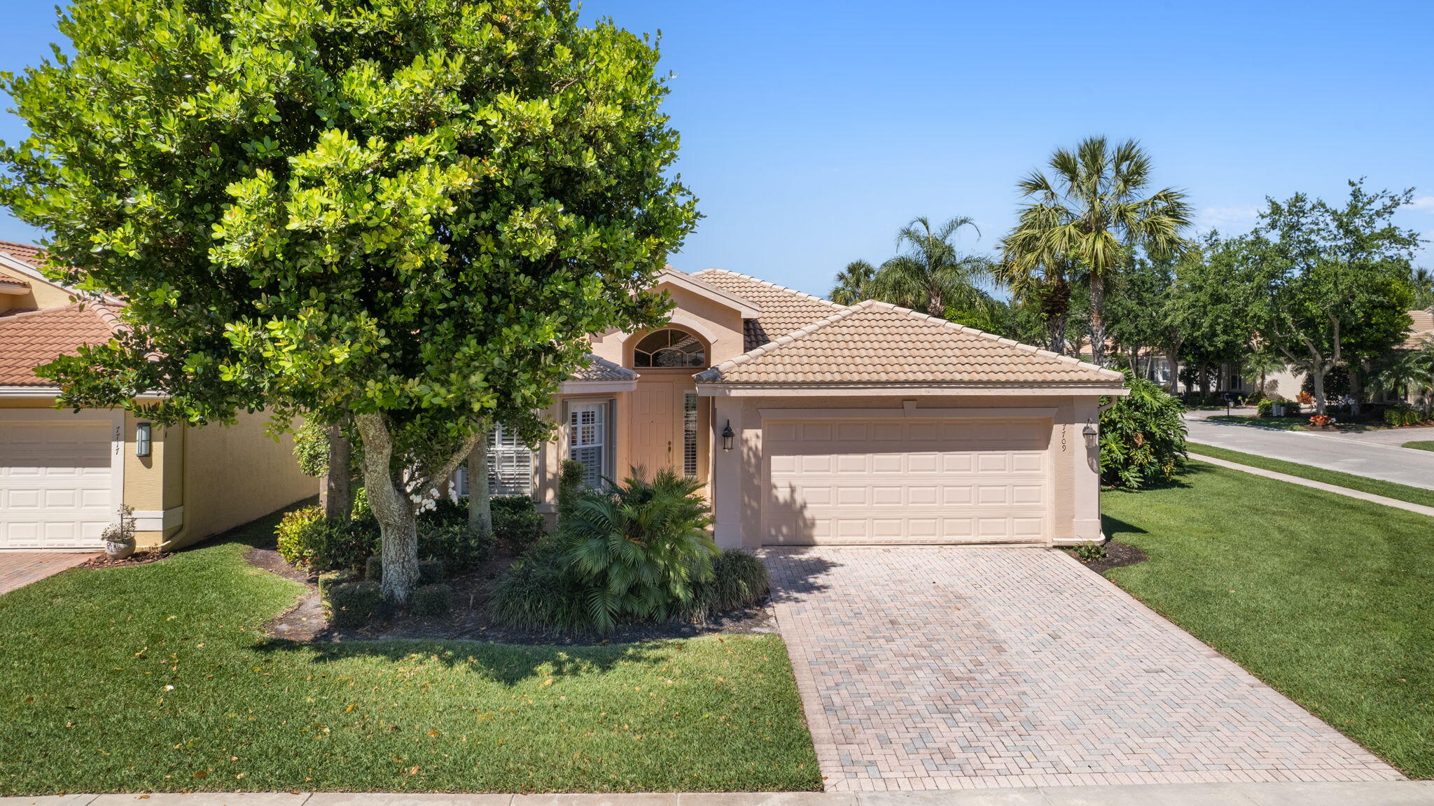 a front view of a house with a yard and trees