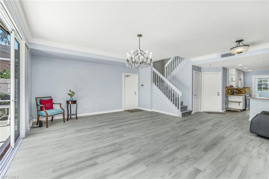 a view of a room with wooden floor and stairs