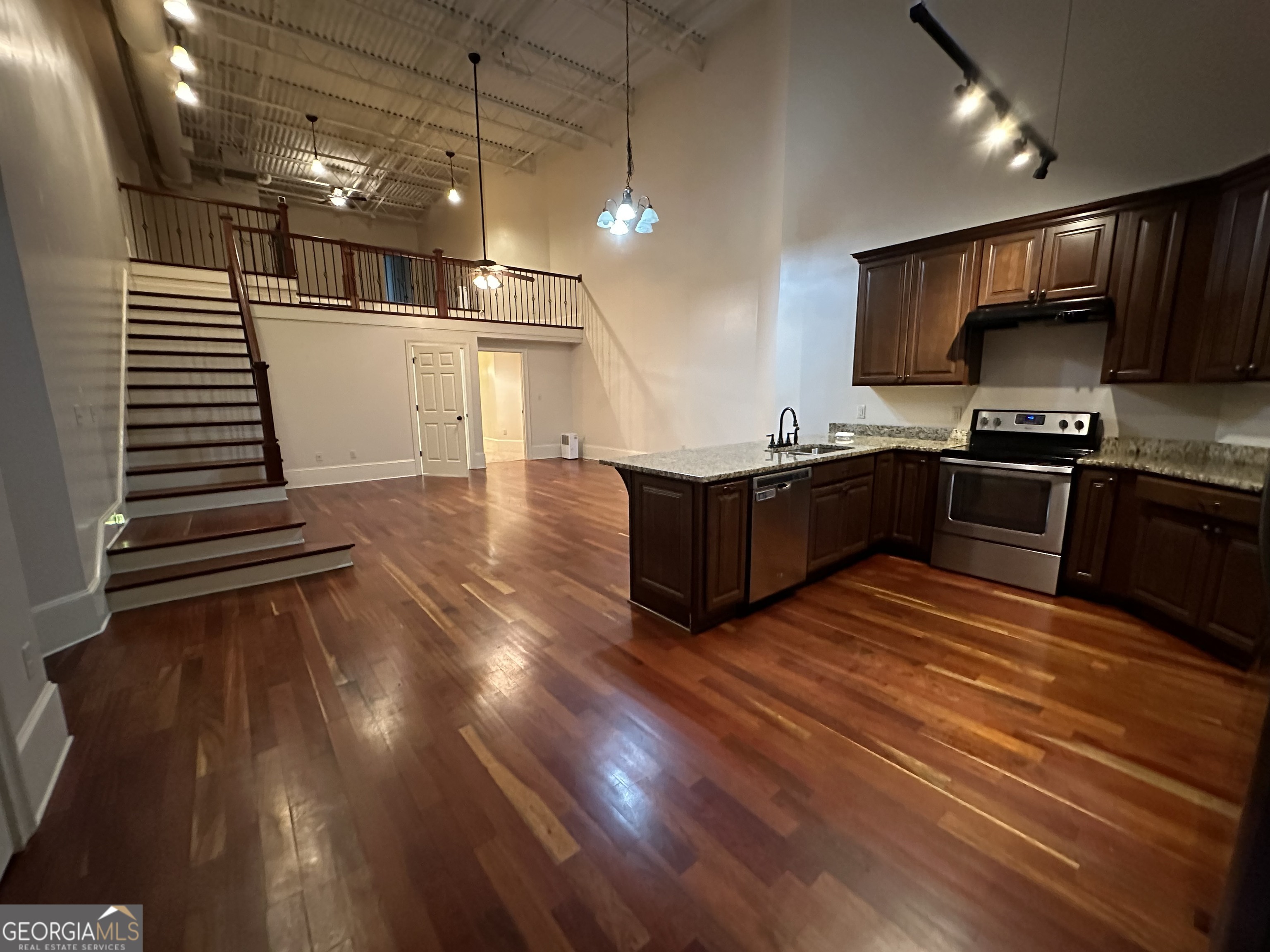 a kitchen with stainless steel appliances a stove a sink dishwasher and a refrigerator