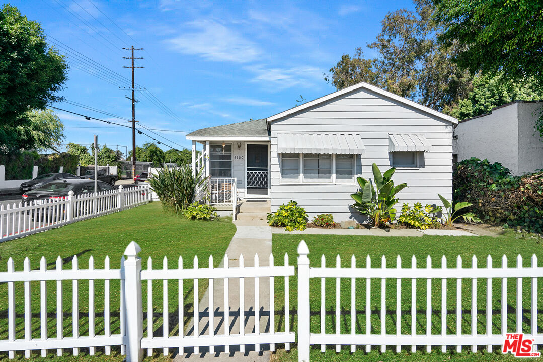 a front view of house with a garden