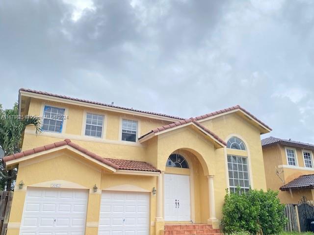 a view of a house with a windows and a small yard