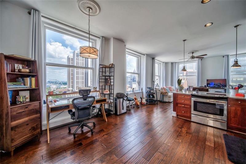 a living room with furniture window and wooden floor