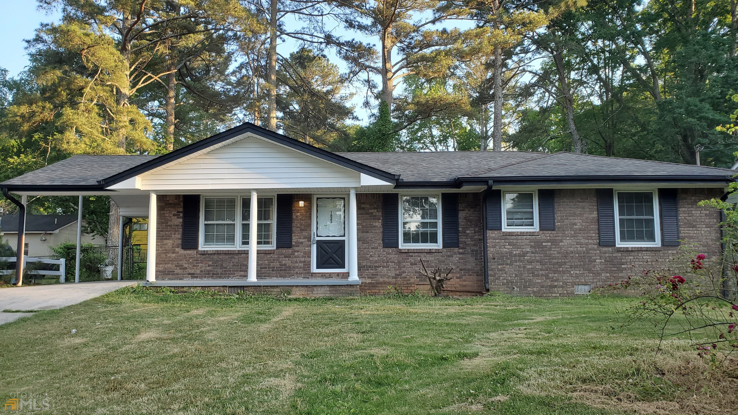 a front view of a house with a garden