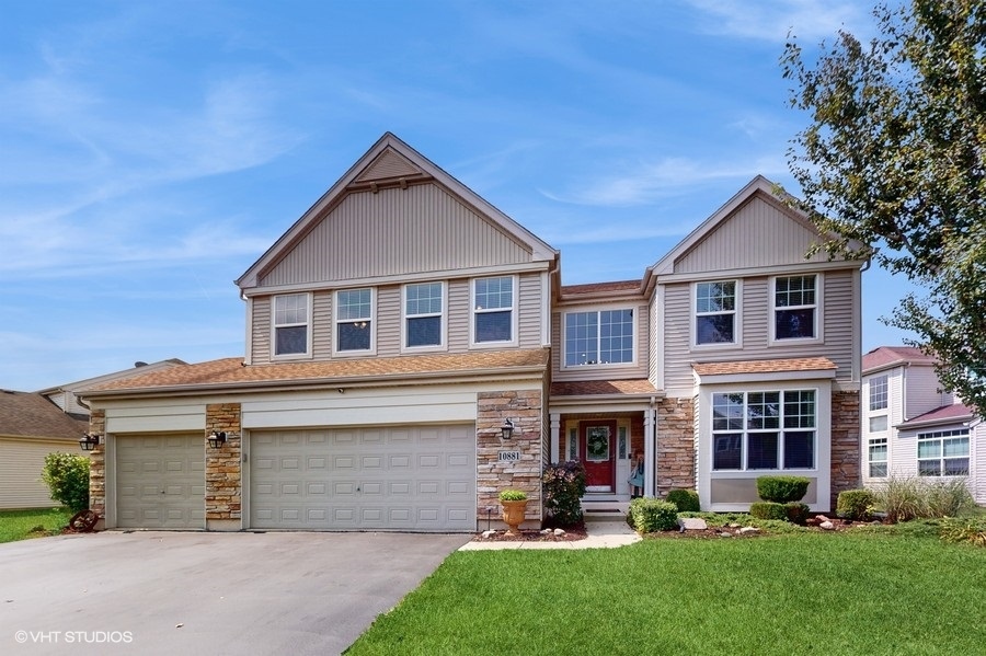 a front view of a house with a yard and garage