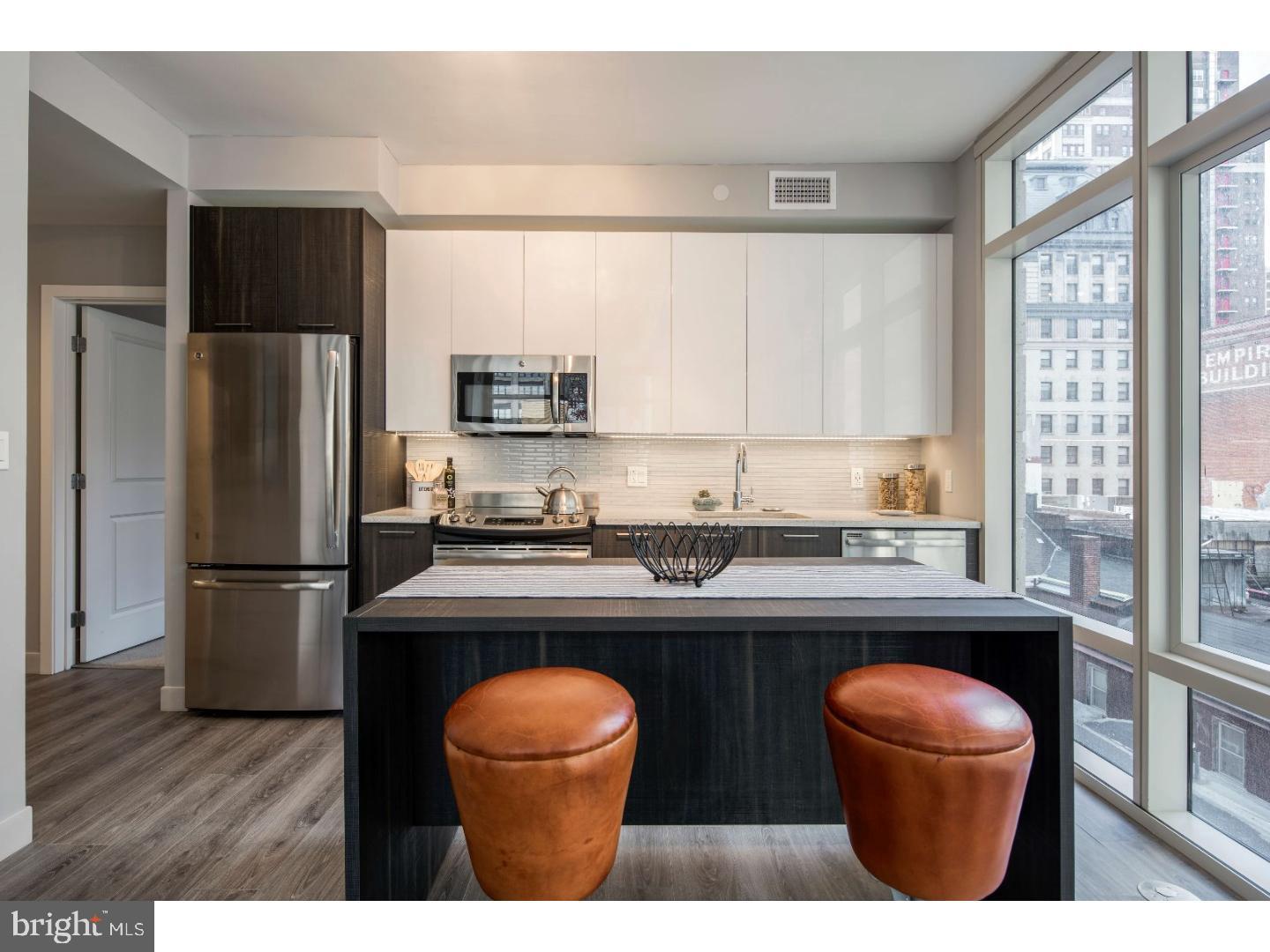 a kitchen with stainless steel appliances a sink stove and refrigerator