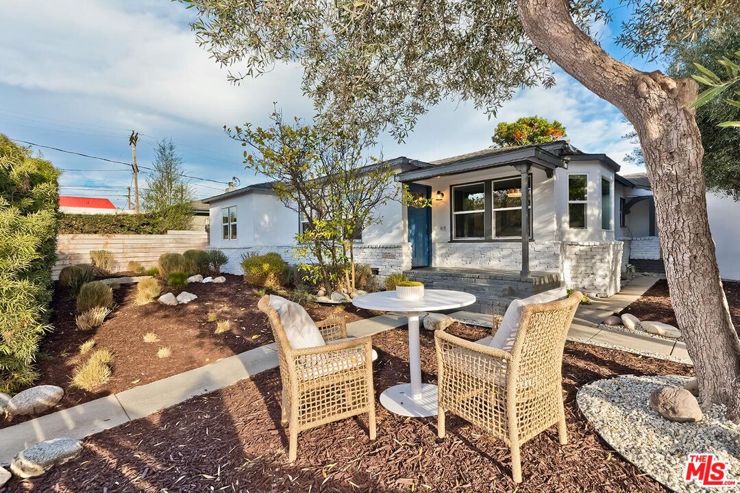 a view of a patio with table and chairs and potted plants