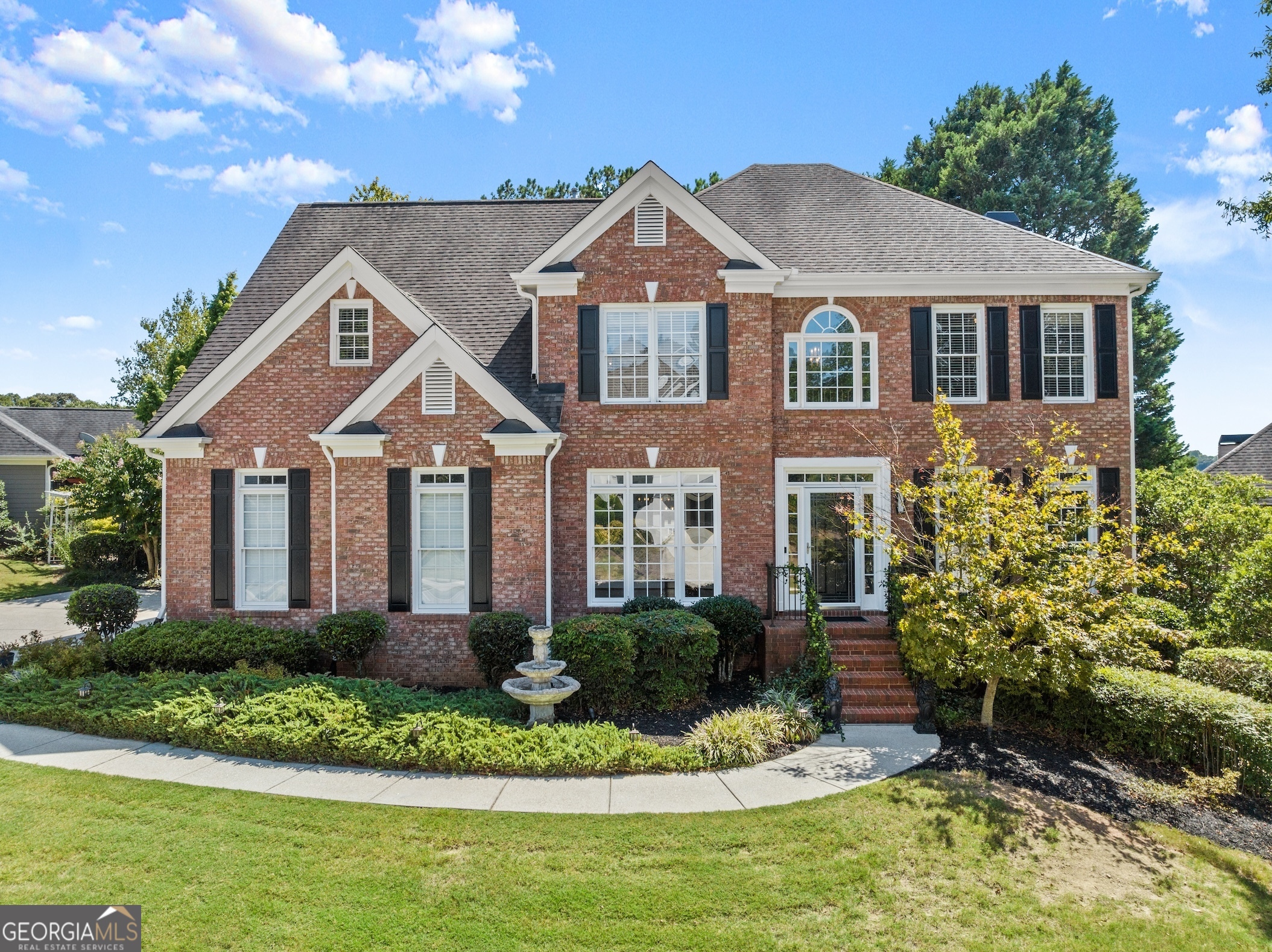 a front view of a house with a yard