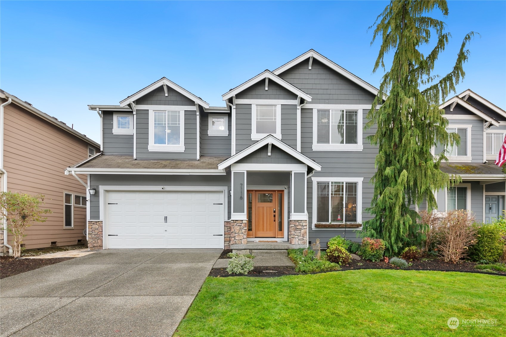 a front view of a house with a yard and garage