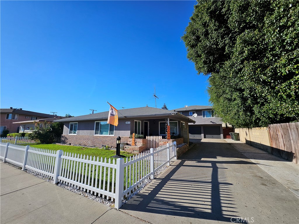 a view of a house with wooden deck and furniture