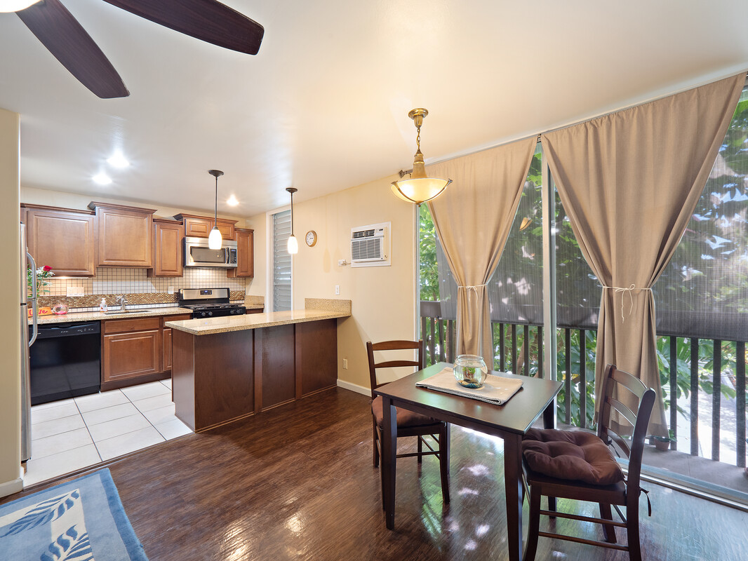 a kitchen with a table chairs sink and cabinets