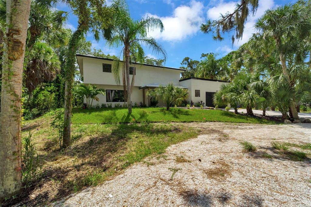 Front of home showing spacious lot and circle drive