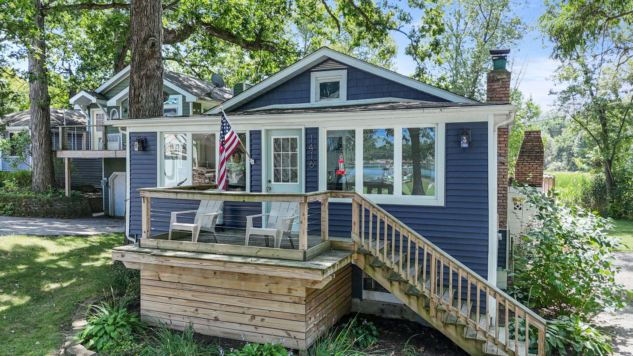 a front view of house with yard outdoor seating and green space