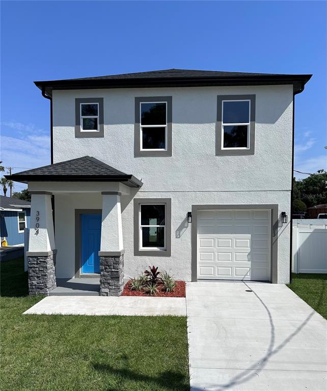 a front view of a house with a yard and garage