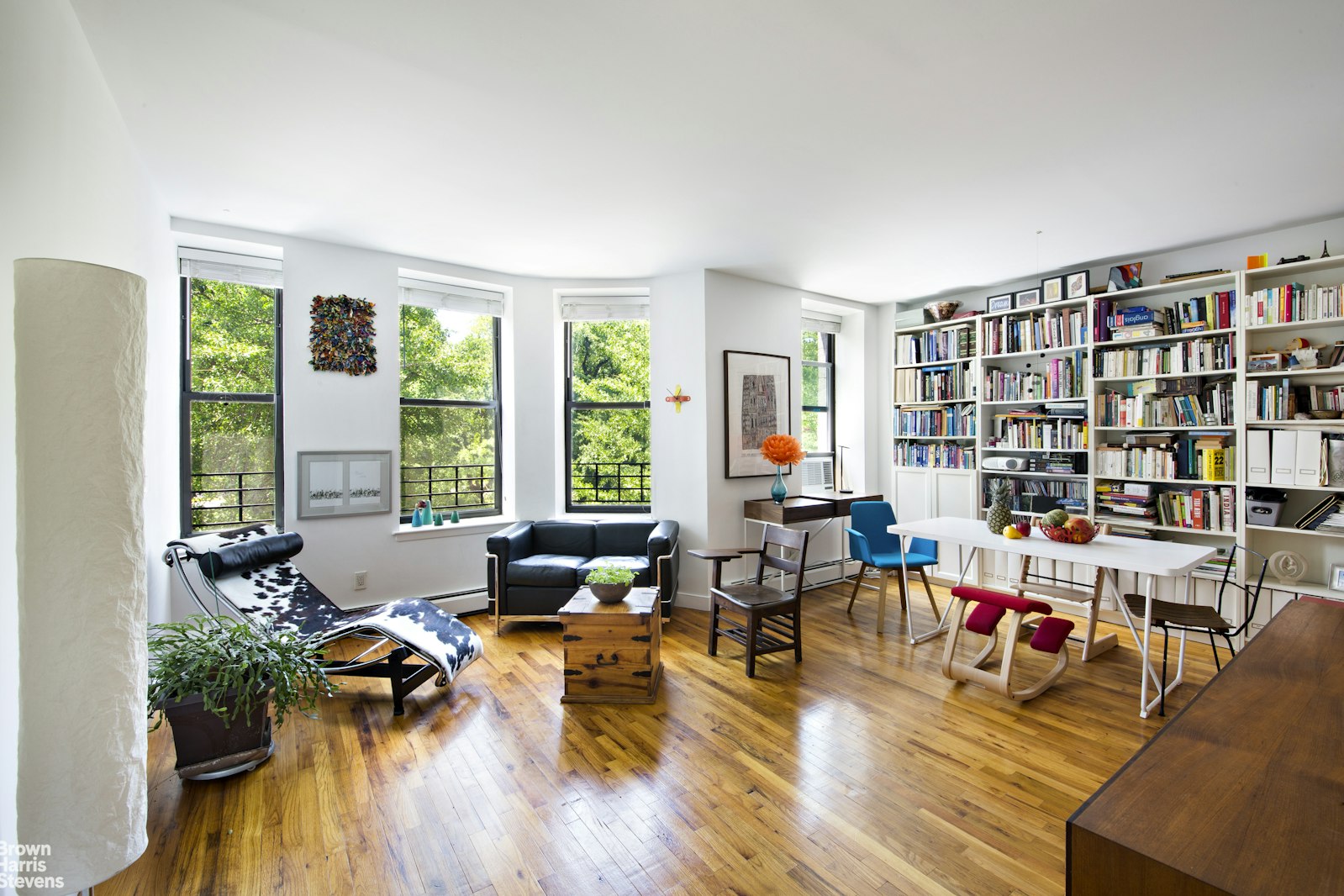 a living room with furniture and a book shelf