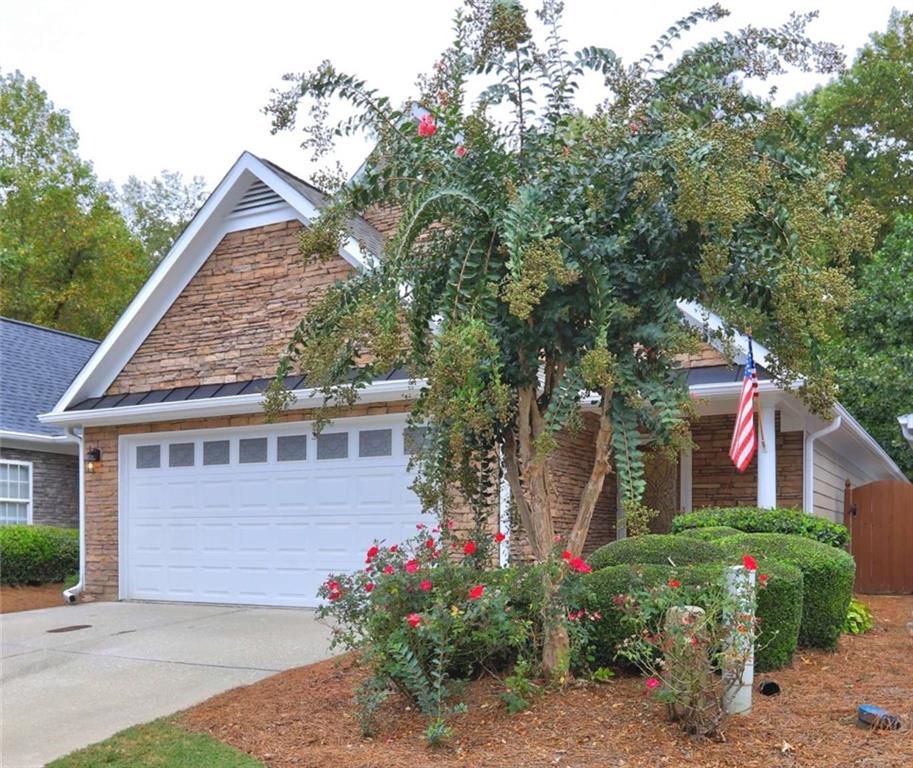 a front view of a house with a garden