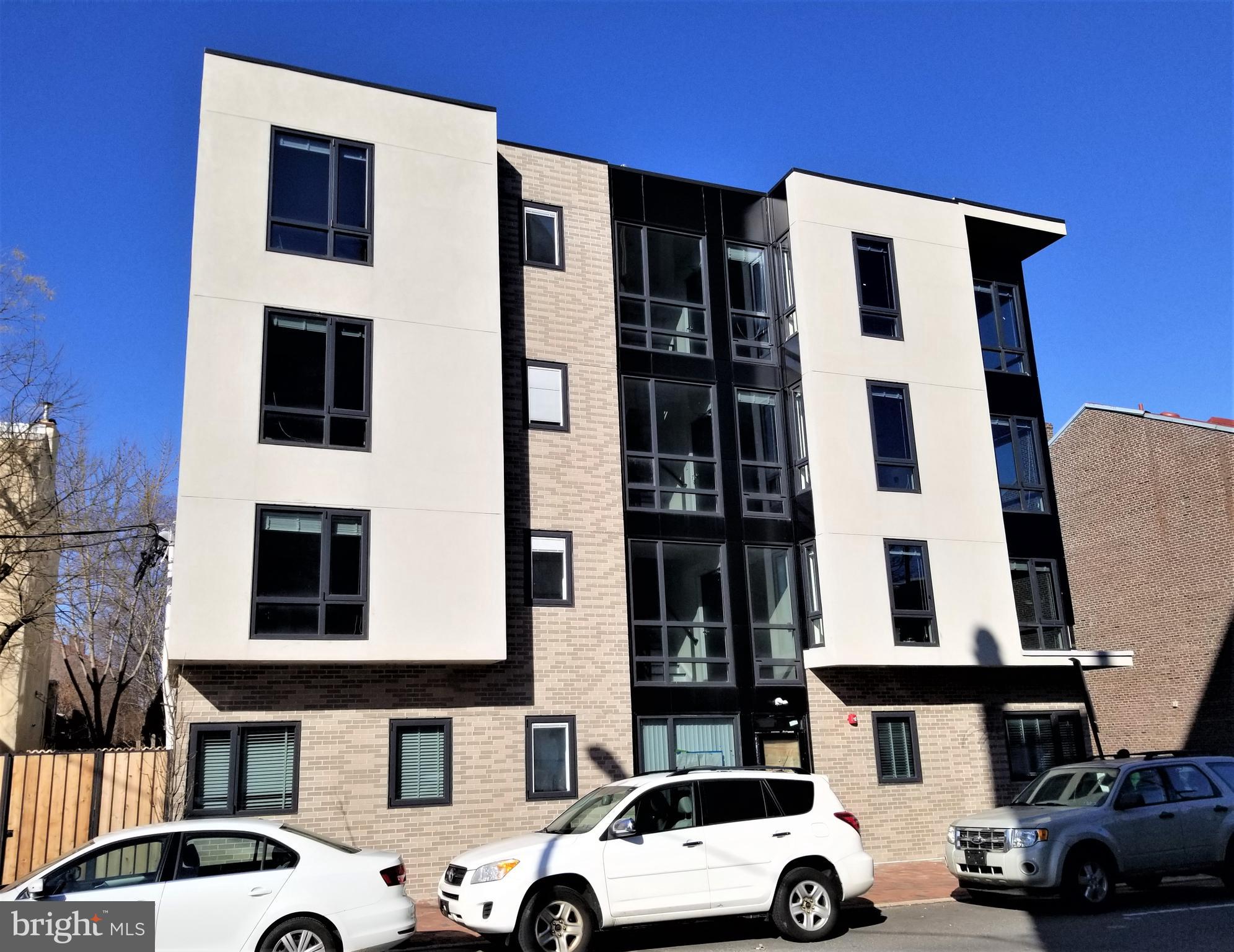 a front view of a building with parking space