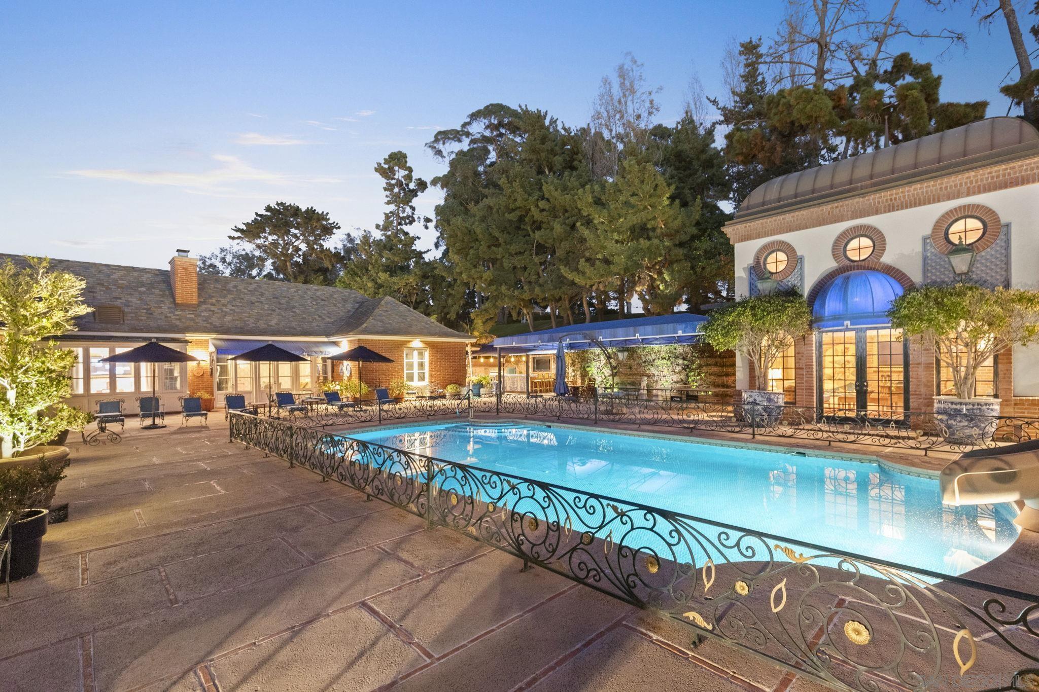 a view of a swimming pool with outdoor seating