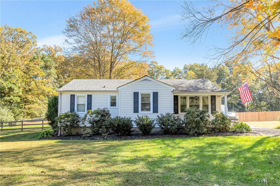 a front view of house with yard and trees around