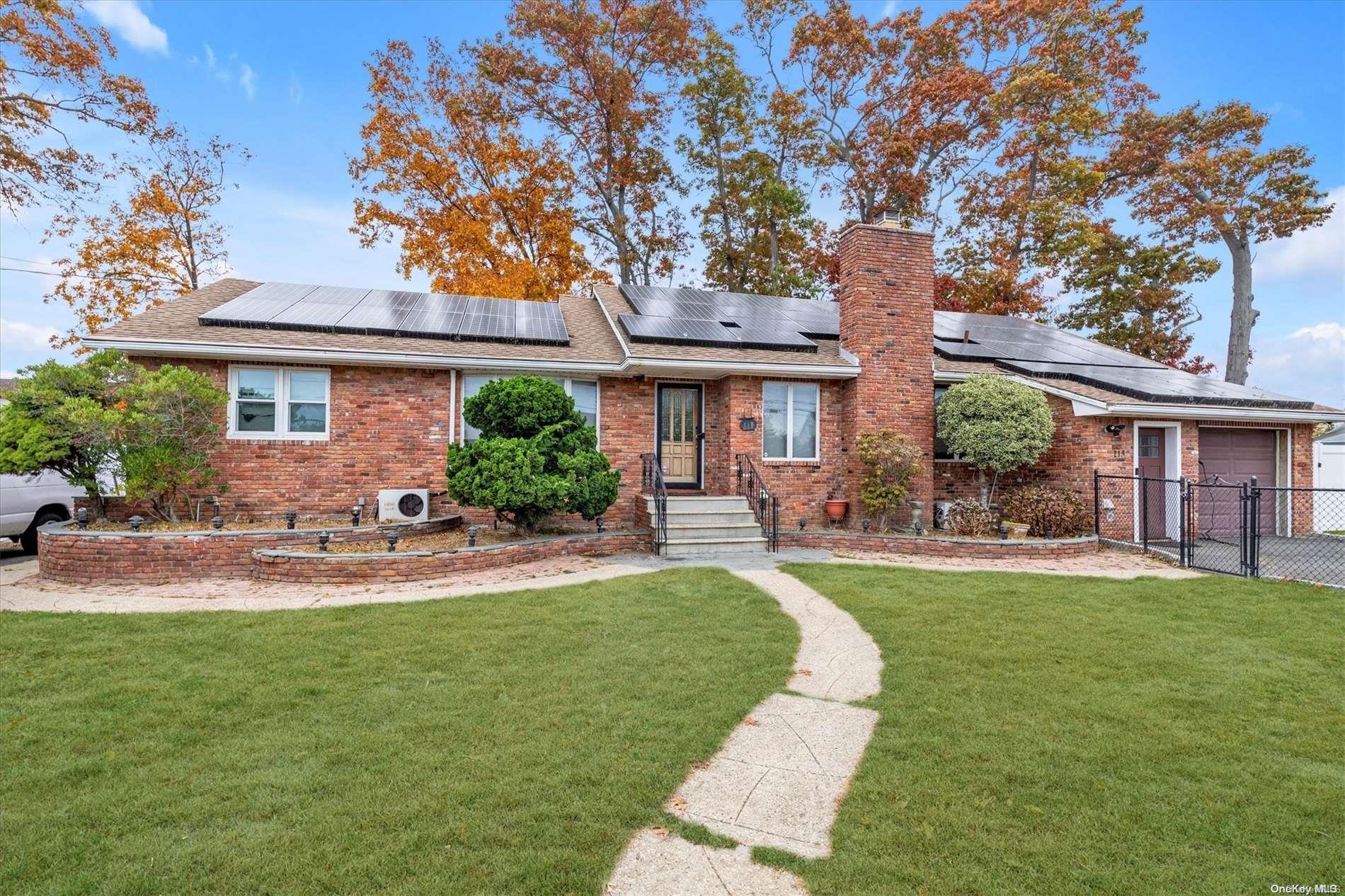 a front view of a house with a yard and outdoor seating