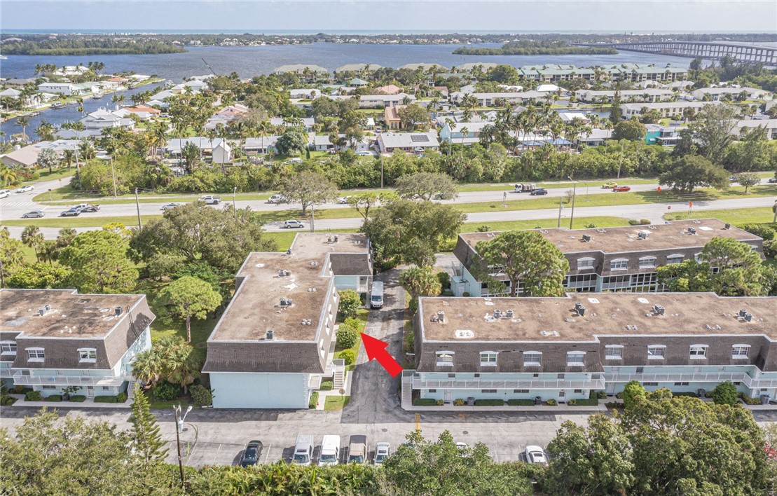 an aerial view of residential houses with outdoor space and river