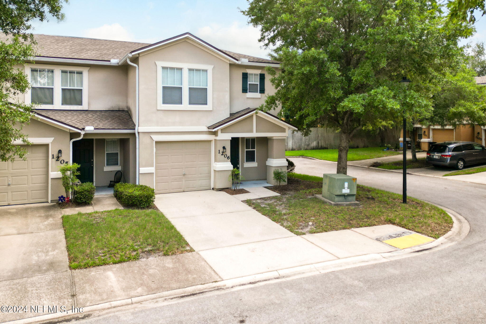 a front view of a house with a yard garage and outdoor seating