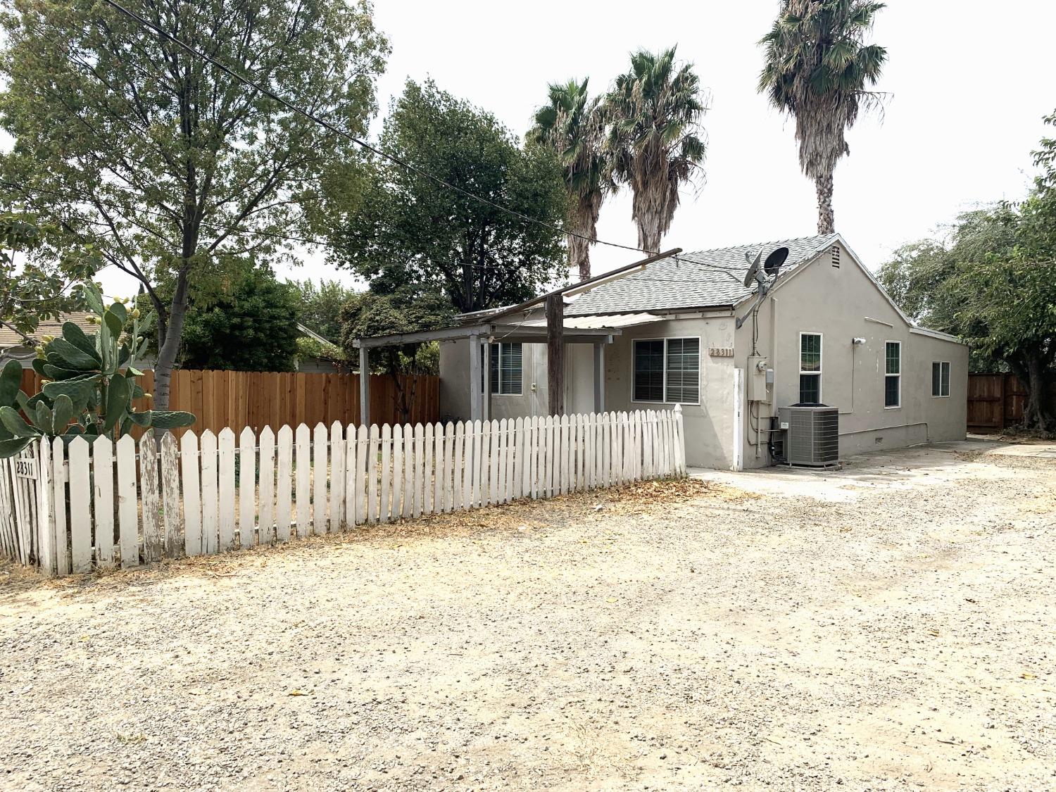 a front view of a house with a fence