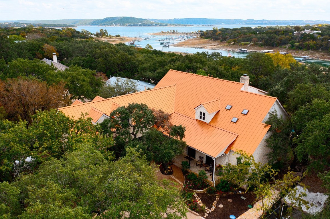 an aerial view of a house with a yard and lake view