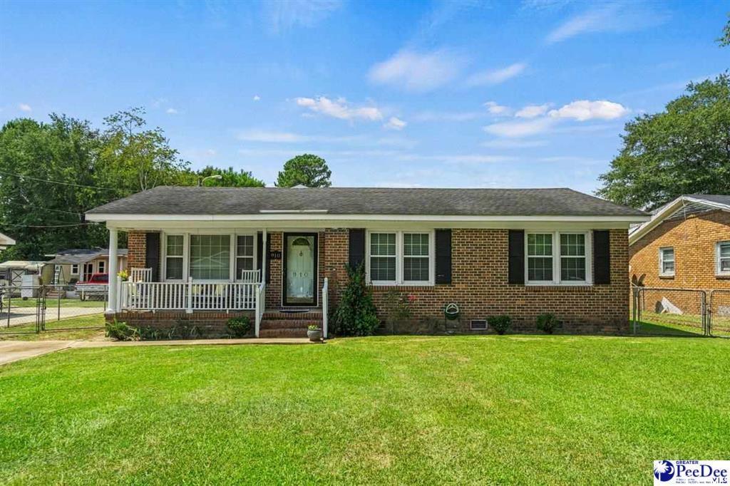 Single story home featuring a porch and a front la