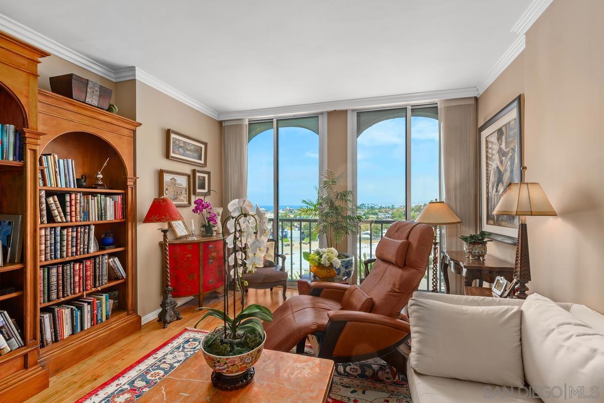 a living room with furniture fireplace and a large window