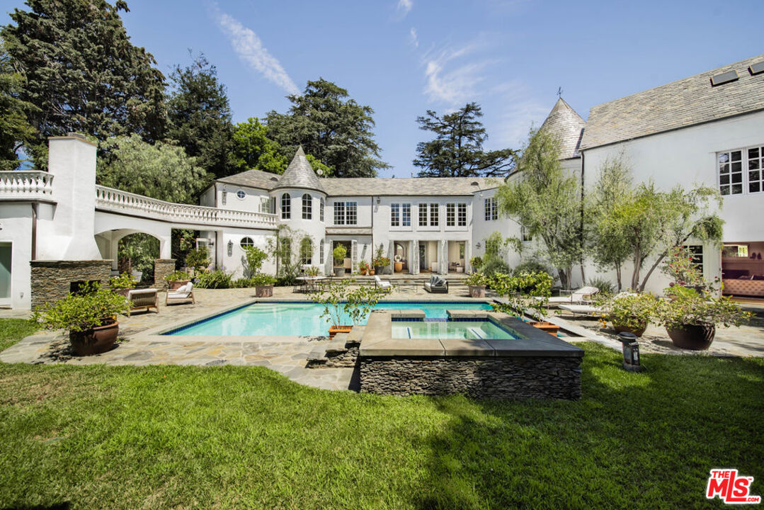 a view of a house with swimming pool and sitting area