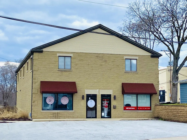 a front view of a house with lots of windows and garage