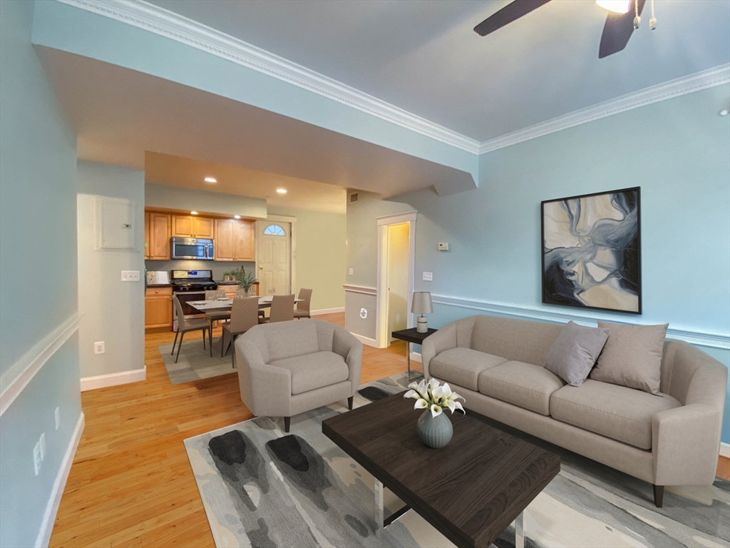 a living room with furniture kitchen view and a table