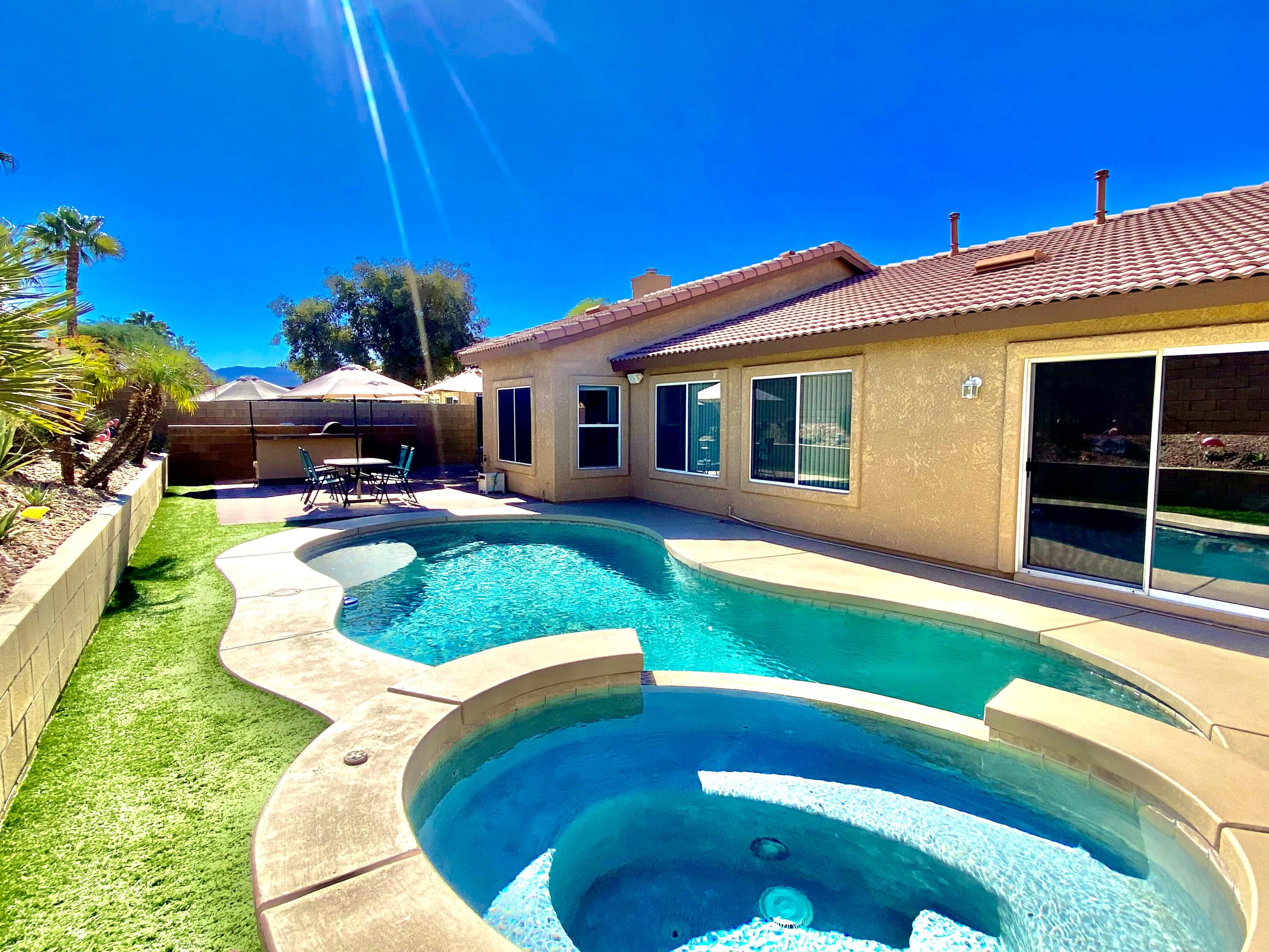 a view of a house with a backyard porch and sitting area