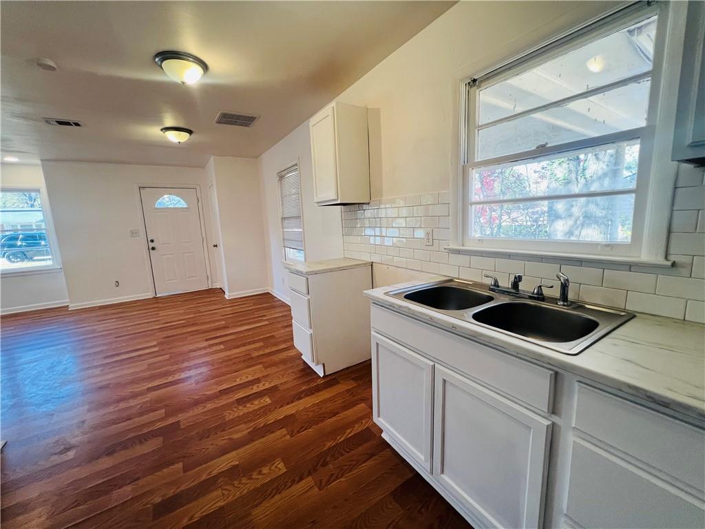 a kitchen with a sink and a stove top oven