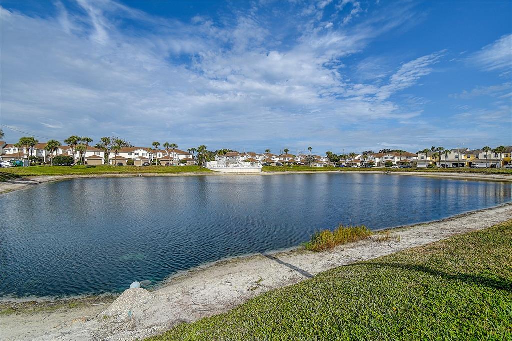 a view of a lake with houses in the back