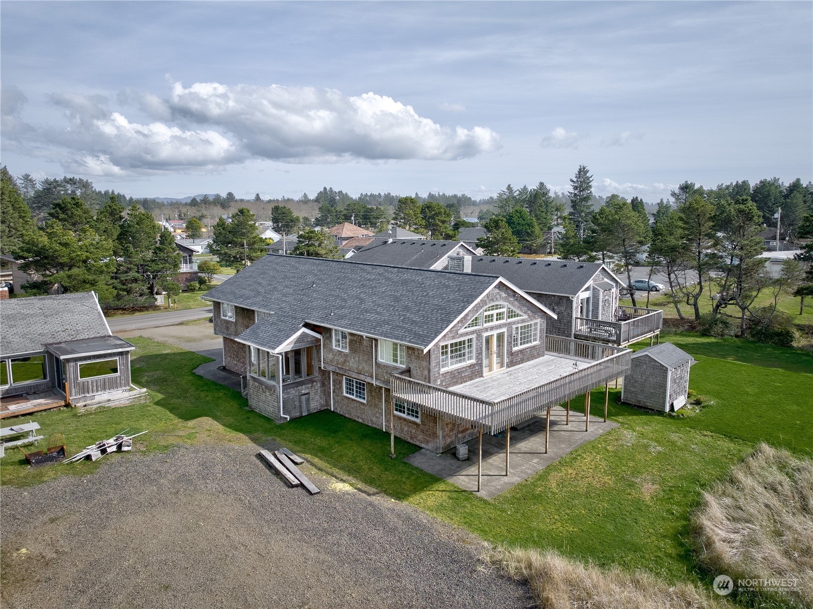 a aerial view of a house with a yard table and chairs