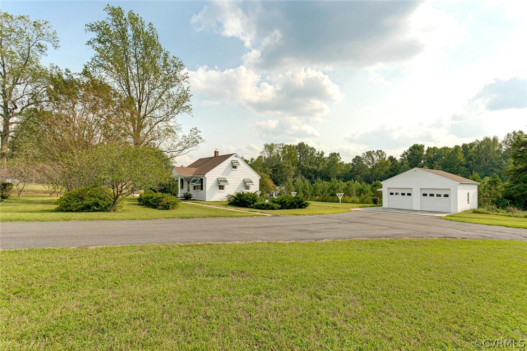 a view of a house with a yard and garage