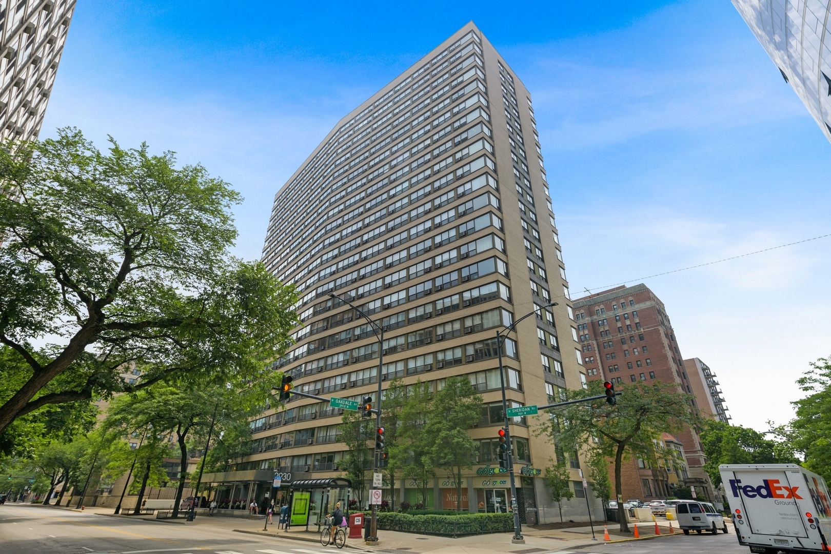 a view of a tall building next to a road