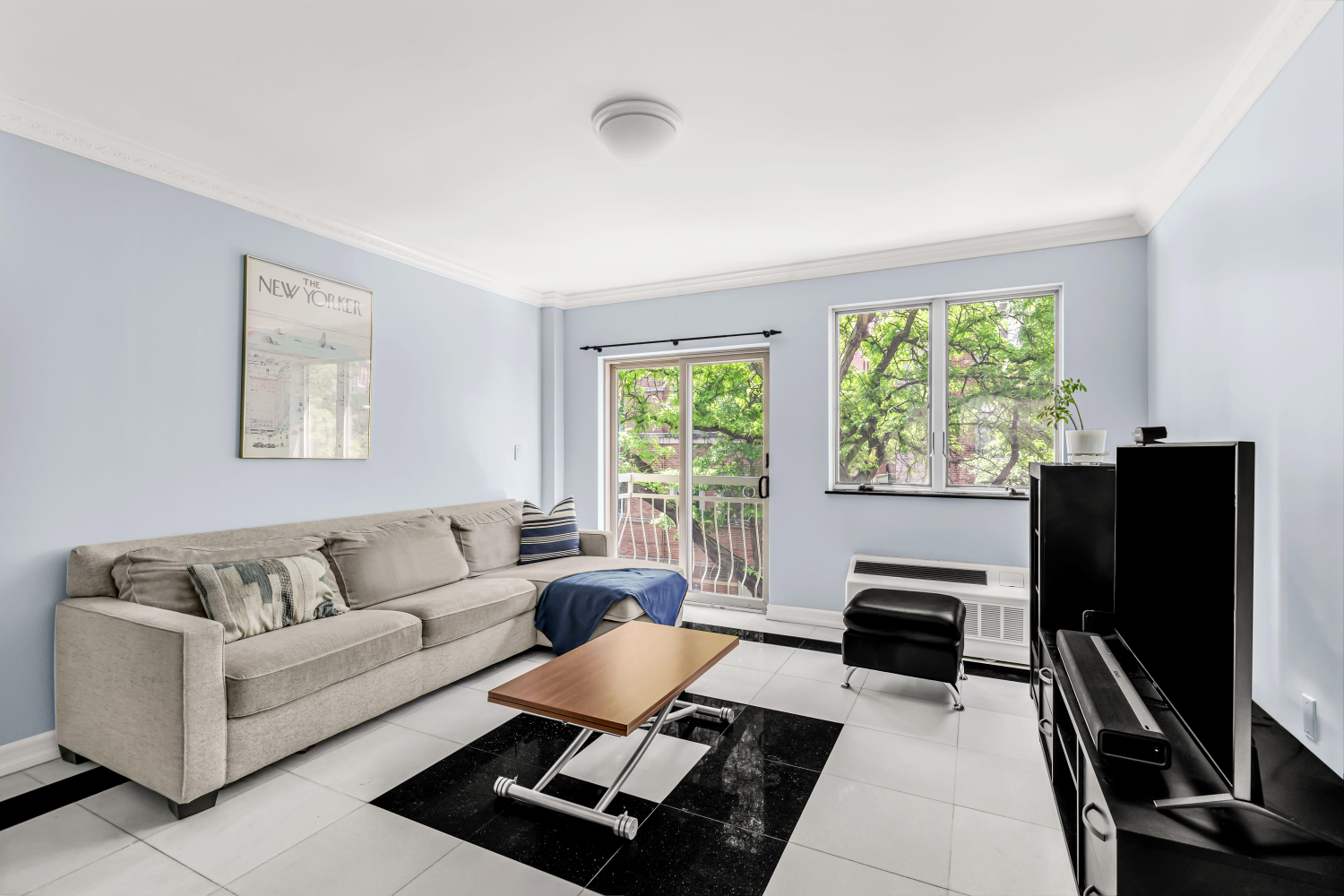 a living room with furniture flat screen tv and a window