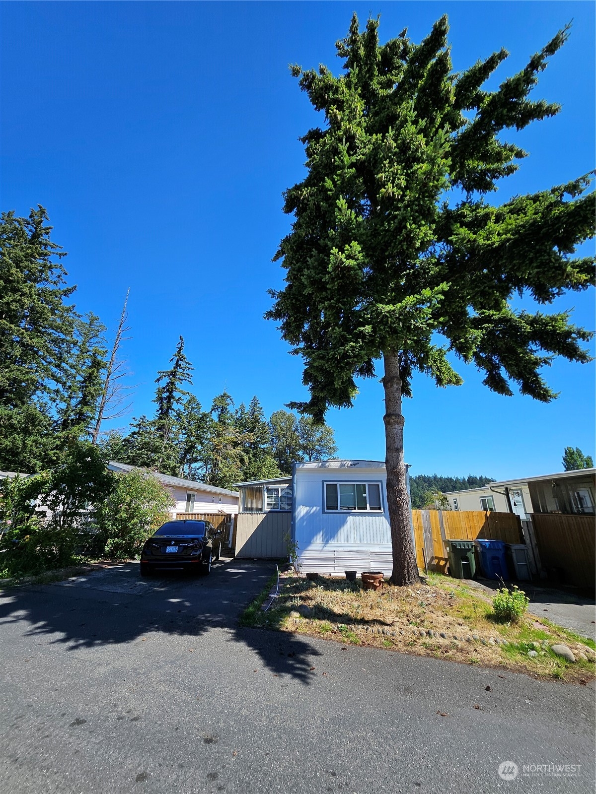 a couple of cars parked in front of a house