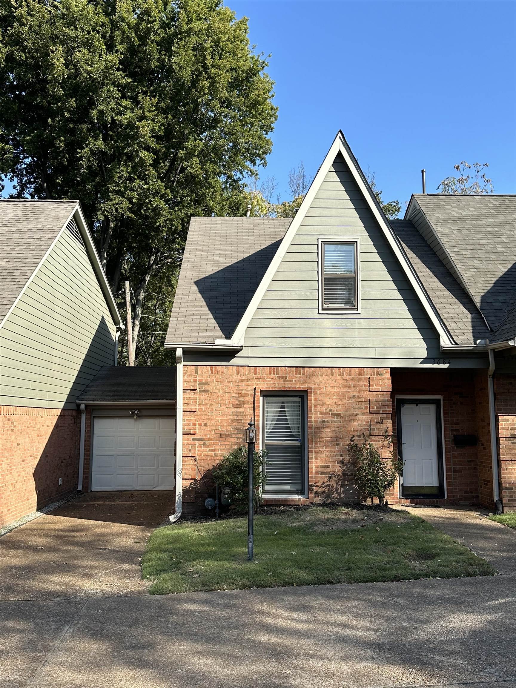 a view of a house with a yard and garage