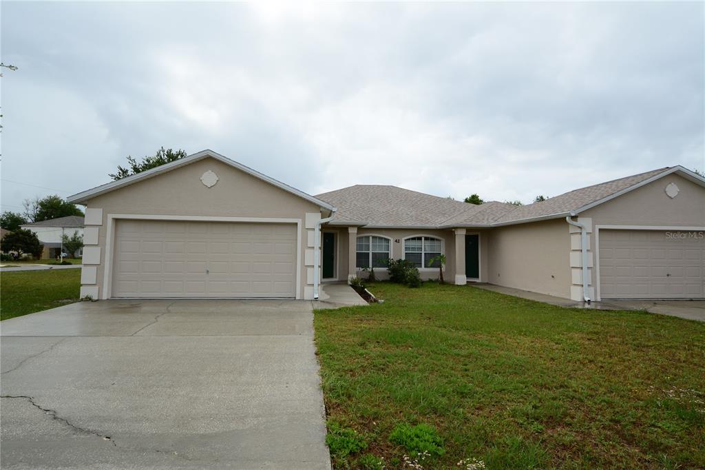 a view of a house with a yard and garage