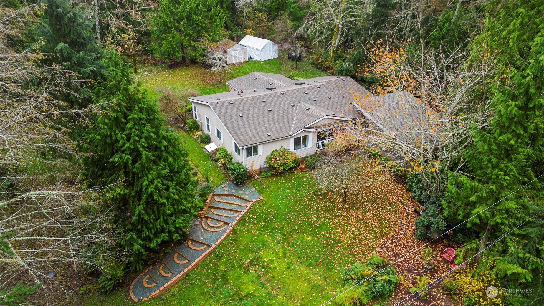 a aerial view of a house with a yard basket ball court and outdoor seating