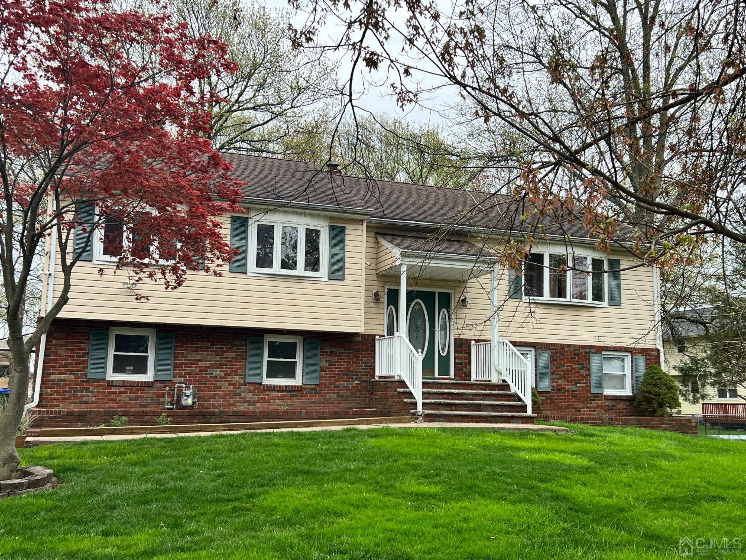 a front view of a house with a garden