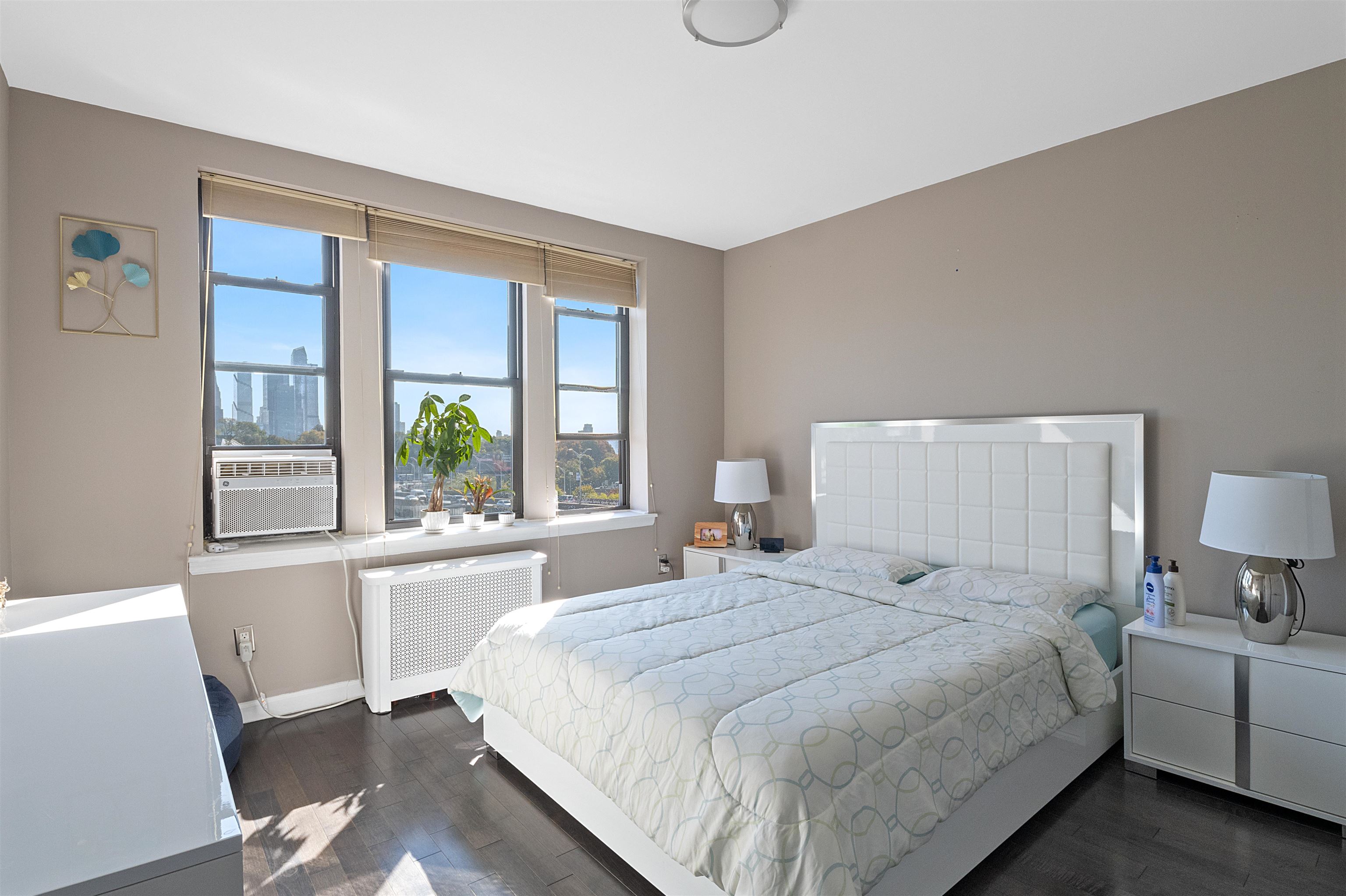 a bedroom with a large bed and a large window