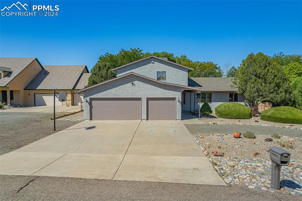 a front view of a house with a yard and garage