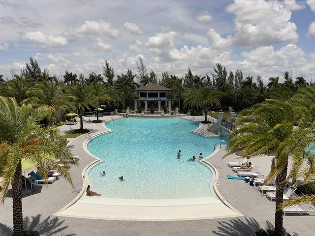 a view of a swimming pool with a patio and a yard