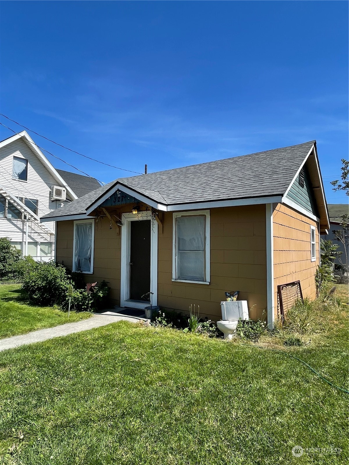 a front view of house with yard and green space